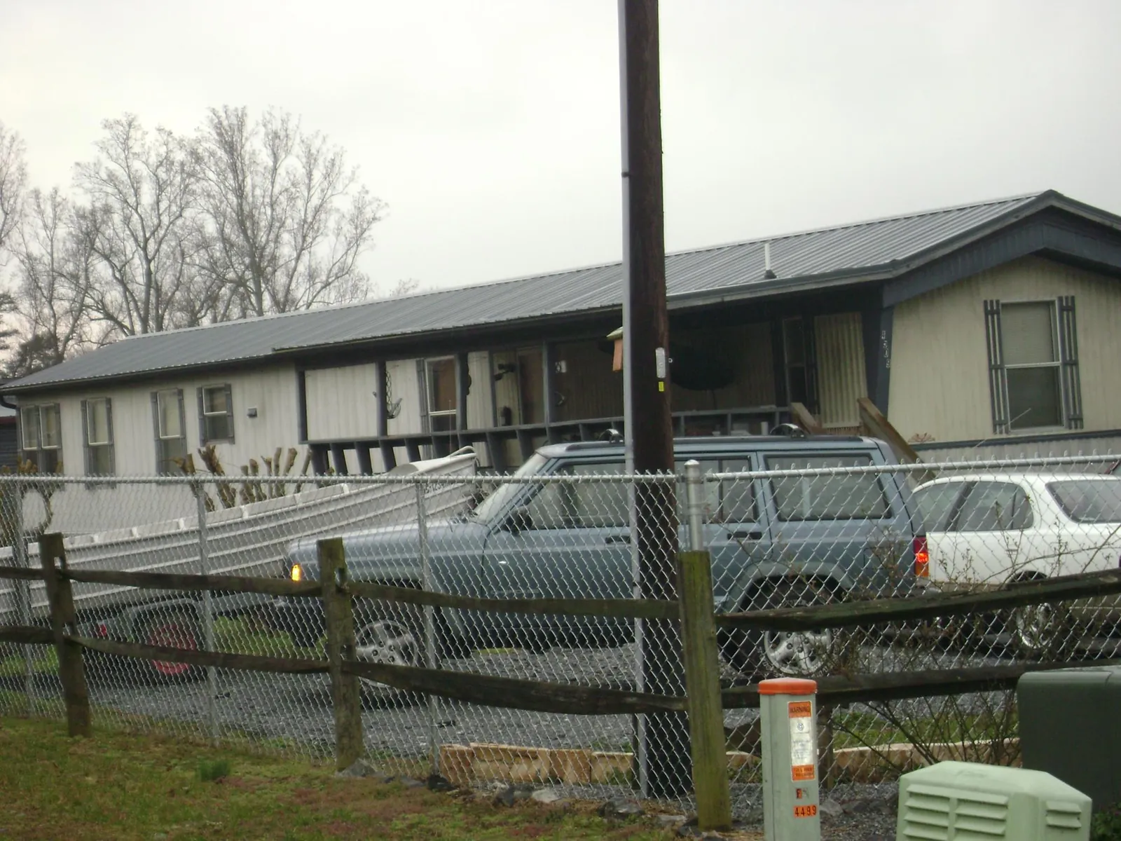 Dark metal roof on a long single story building behind a chain link fence in Copalis Crossing